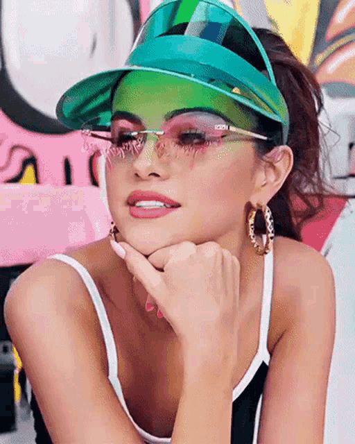 a woman wearing a green visor and sunglasses with the word gucci on the lenses