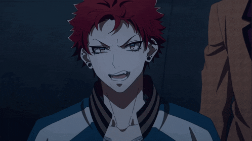 a man with red hair and a blue jacket is making a funny face
