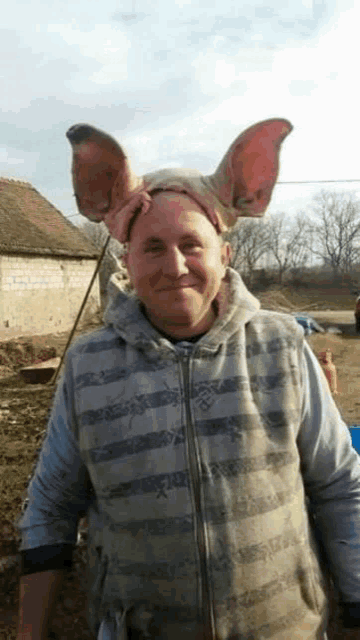 a man with pig ears on his head and a striped vest