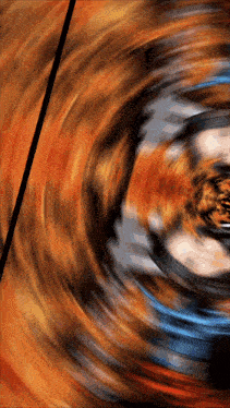 a blurred image of a spinning object with a black stripe in the middle