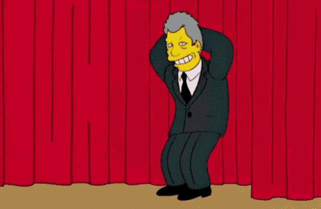 a cartoon character is standing in front of a red curtain .