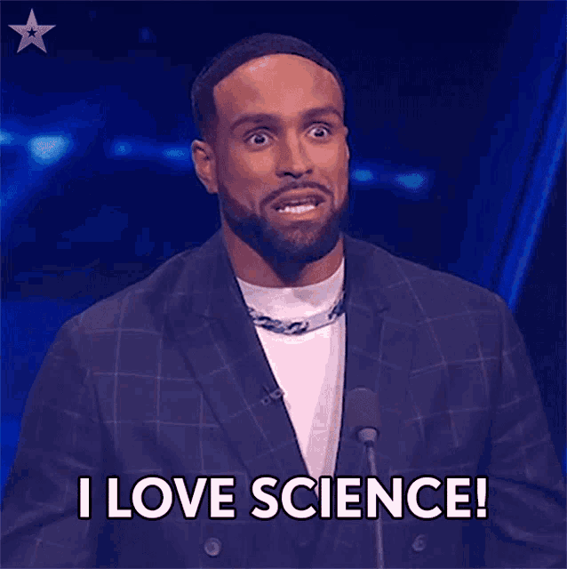 a man in a suit is speaking into a microphone and says i love science