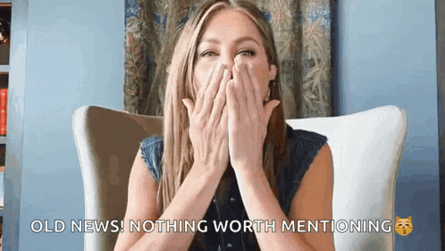 a woman is covering her mouth with her hands while sitting in a chair and says old news nothing worth mentioning