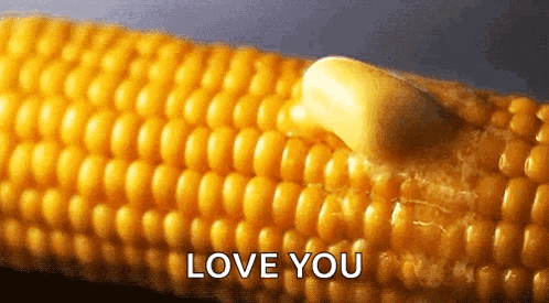 corn on the cob with butter on it and the words love you written below it