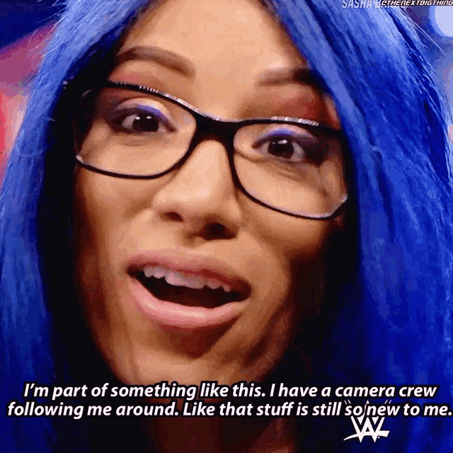 a woman with blue hair is wearing glasses and says i 'm part of something like this