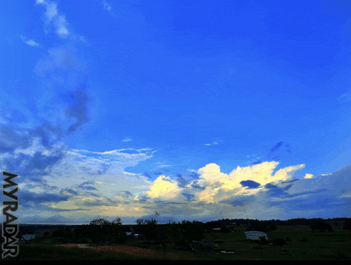 a picture of a cloudy sky with myadar written in the corner