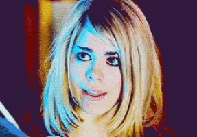 a close up of a woman with blonde hair and blue eyes