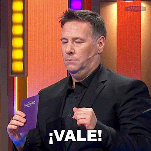 a man in a suit is holding a purple book that says vale on it