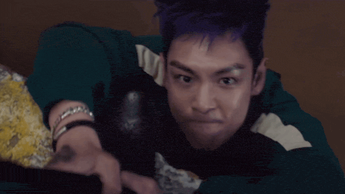 a man with purple hair has the words dude you won 't be able to written below him