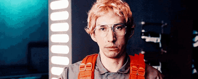 a man wearing glasses and a wig is standing in a room