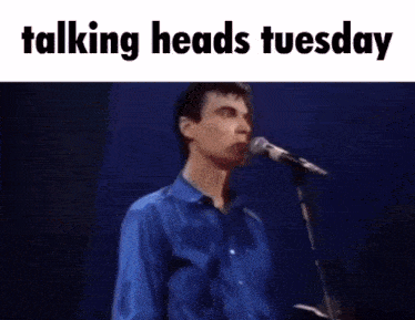 a man singing into a microphone with the text talking heads tuesday