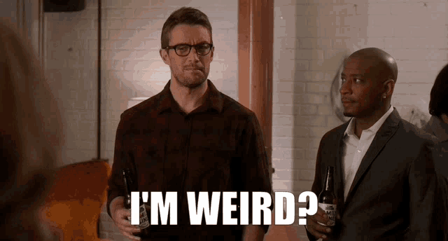 two men standing next to each other with one saying i 'm weird .