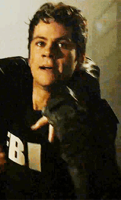 a close up of a man wearing a fbi hoodie