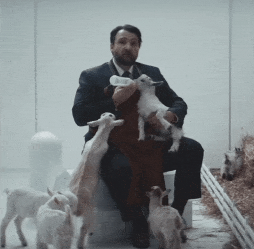 a man holding a baby goat with the words you can 't take them yet below him