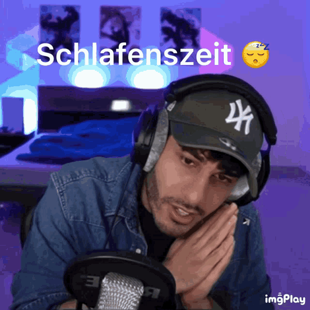 a man wearing headphones and a ny hat with the word schlafenzeit written above him