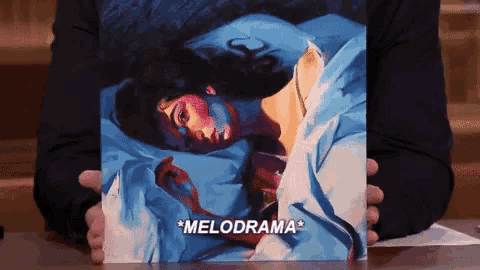 a person is holding a picture of a woman laying in a bed with the words melodrama on the cover