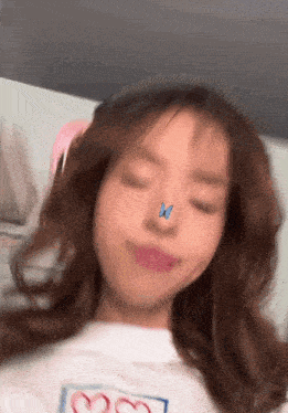 a woman with a butterfly on her nose and a heart on her shirt