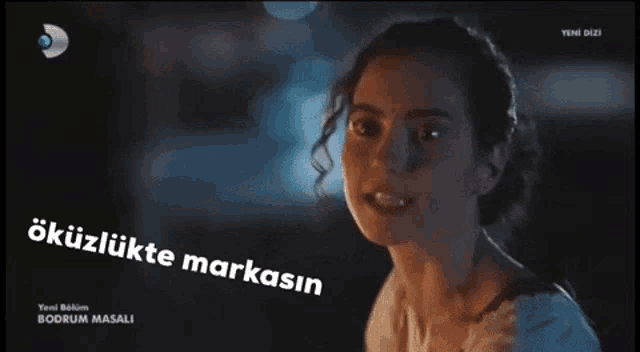 a woman 's face is shown with the words okuzlukte markasin written below her