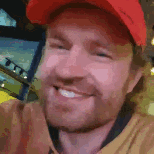 a man wearing a red hat with the word columbia on it