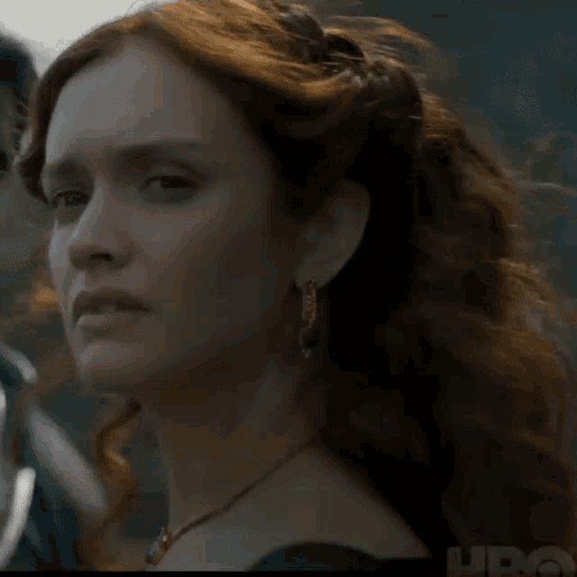 a close up of a woman 's face with a hbo logo in the background