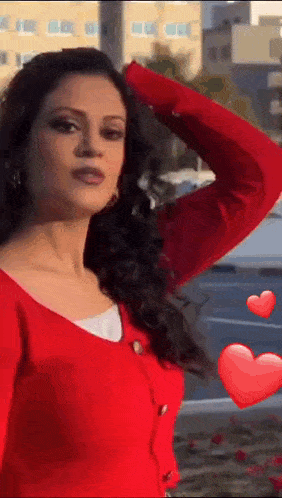 a woman in a red sweater with hearts floating around her