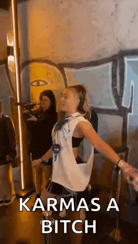 a woman is dancing in a room with the words karmas a bitch written on the bottom .