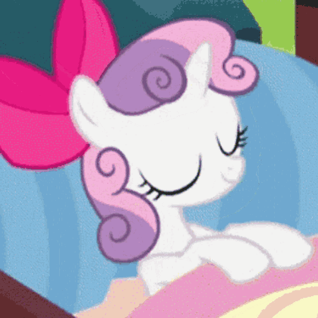 a cartoon pony with a pink bow on its head is sleeping in a bed