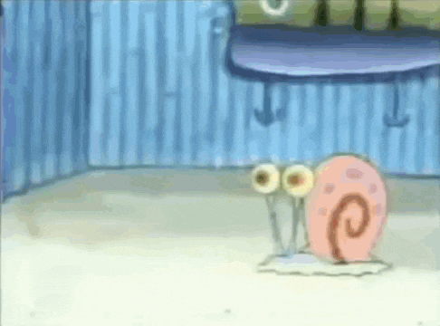 gary the snail from spongebob squarepants is sitting on the floor in a room .
