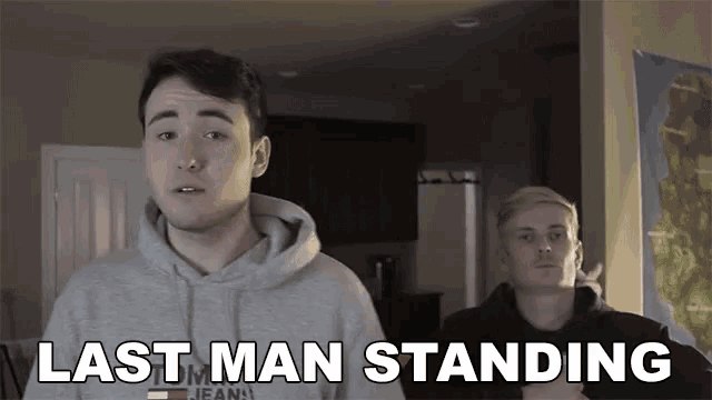 a man in a tommy jeans sweatshirt stands next to another man with the words last man standing above them
