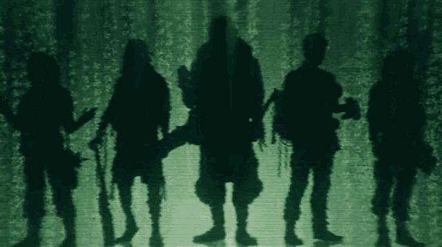 a group of soldiers standing next to each other in a dark room .