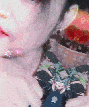 a close up of a woman 's face with a heart shaped sticker on her nose