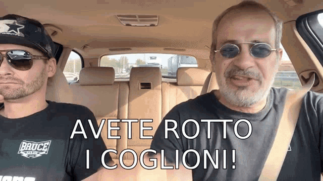 two men in a car with the words avete rotte i coglioni