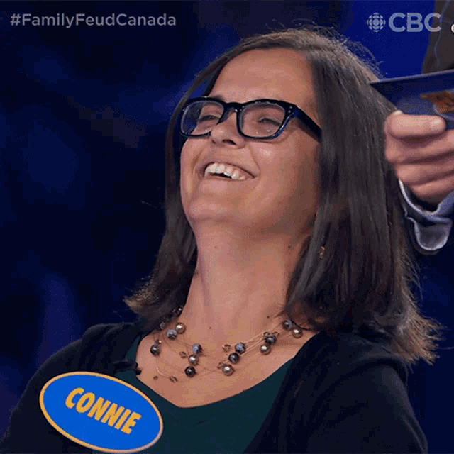 a woman with glasses and a name tag that says connie on it