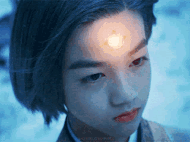 a young girl with a light on her forehead