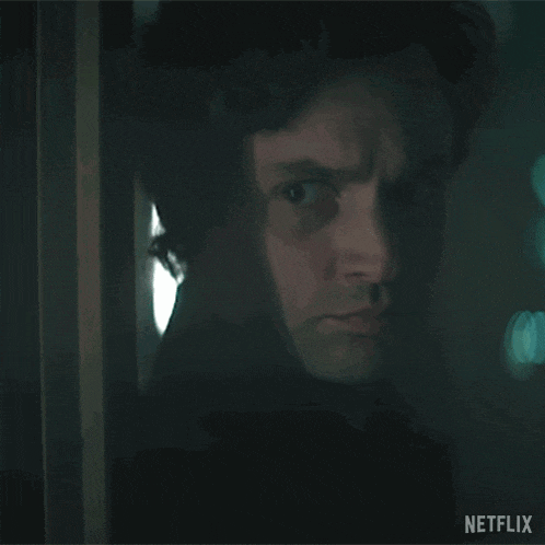 a close up of a man 's face behind a door with a netflix logo in the corner .