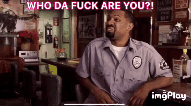a man sitting at a bar with the words who da fuck are you