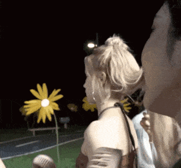 a man and a woman are looking at a flower