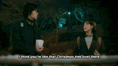 a woman is talking to a man and says `` i think you 're like that christmas tree over there '' .