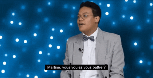 a man in a suit and bow tie says martine vous vouulez vous battre