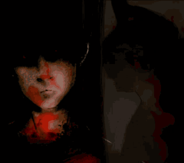 a painting of a man 's face and a woman 's face in a dark room