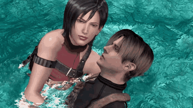 a man and a woman are standing in the water and the woman is wearing a red top