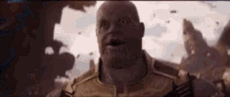 a close up of thanos from avengers : infinity war making a funny face with his mouth open .