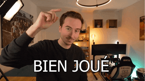 a man in a room with the words bien joue written on it