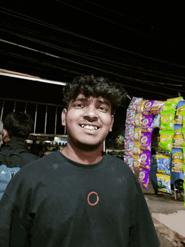 a young man wearing a black shirt with an o on the front