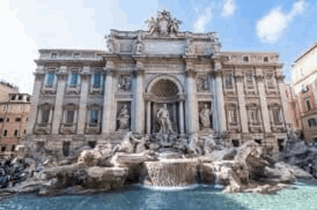 a large building with a fountain in front of it