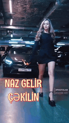 a woman in a black dress is standing in front of a mercedes car .