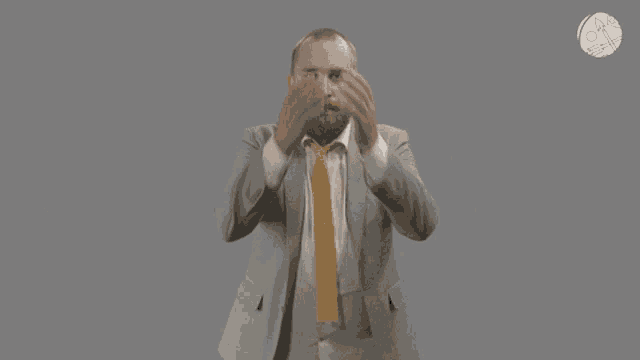 a man in a suit and tie is looking up at the sky