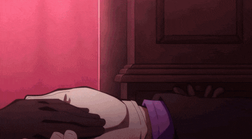 a person laying on a bed with their hands on their stomach