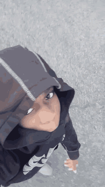 a person wearing a hoodie and a hijab with the letter s on it
