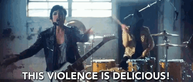 a woman singing into a microphone while a man plays drums with the words " this violence is delicious " below her